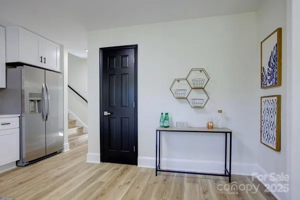 a view of hallway with wooden floor