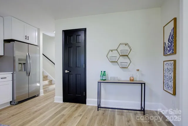 a view of hallway with wooden floor