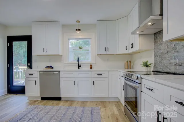 a kitchen with cabinets and wooden floor