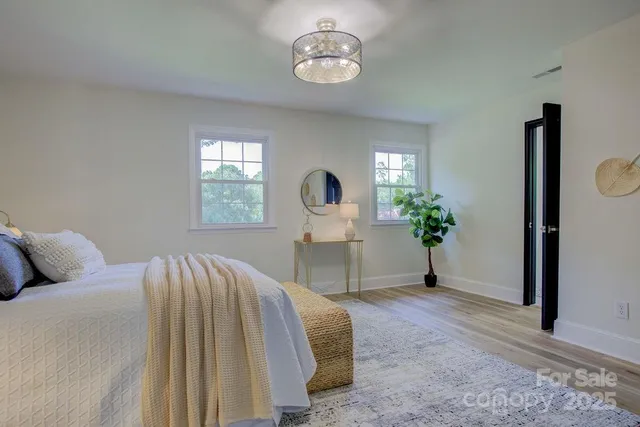 a bed room with a bed and a potted plant