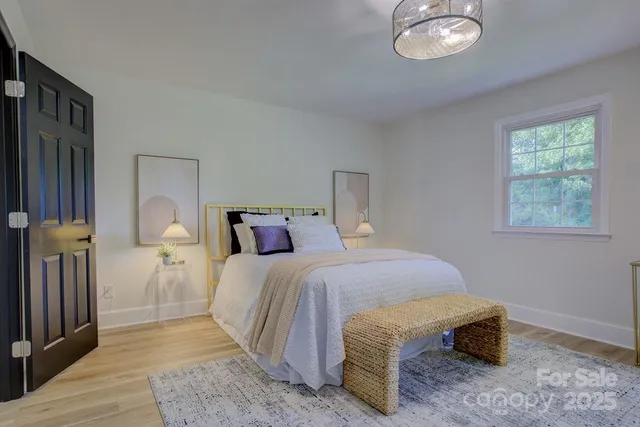 a bedroom with a bed and a chandelier