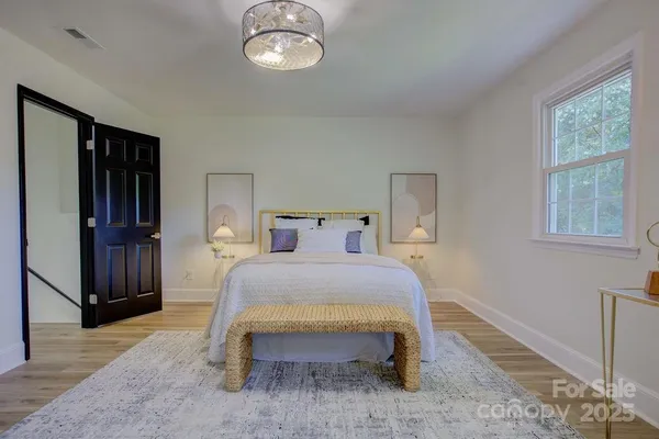 a bedroom with a bed and window