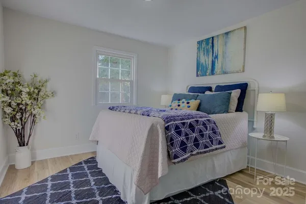 a bedroom with a bed and a potted plant