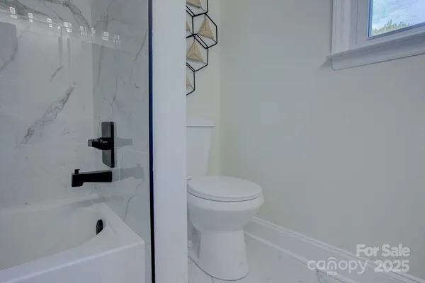 a bathroom with a toilet and shower
