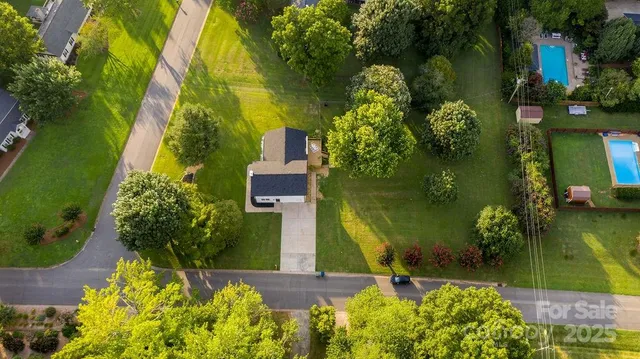 an aerial view of a residential houses with outdoor space