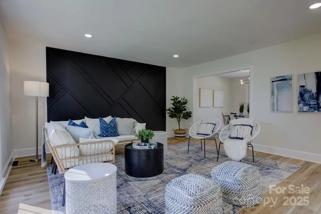 a living room with furniture a rug and a potted plant