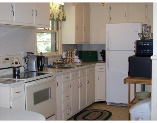 72 West Allen Ridge Road Springfield, MA 01118 - Photo 11 of 16 a kitchen with white cabinets and appliances