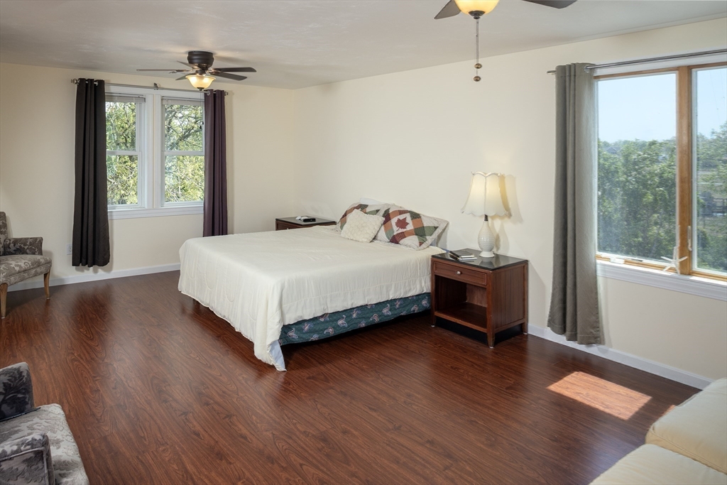67 Newport Road Hull, MA 02045 - Photo 15 of 26 a bedroom with a bed and large windows
