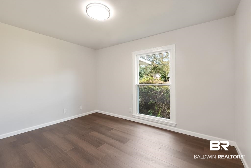 554 Stuart Street Daphne, AL 36526 - Photo 16 of 49 Spare room featuring dark hardwood / wood-style floors