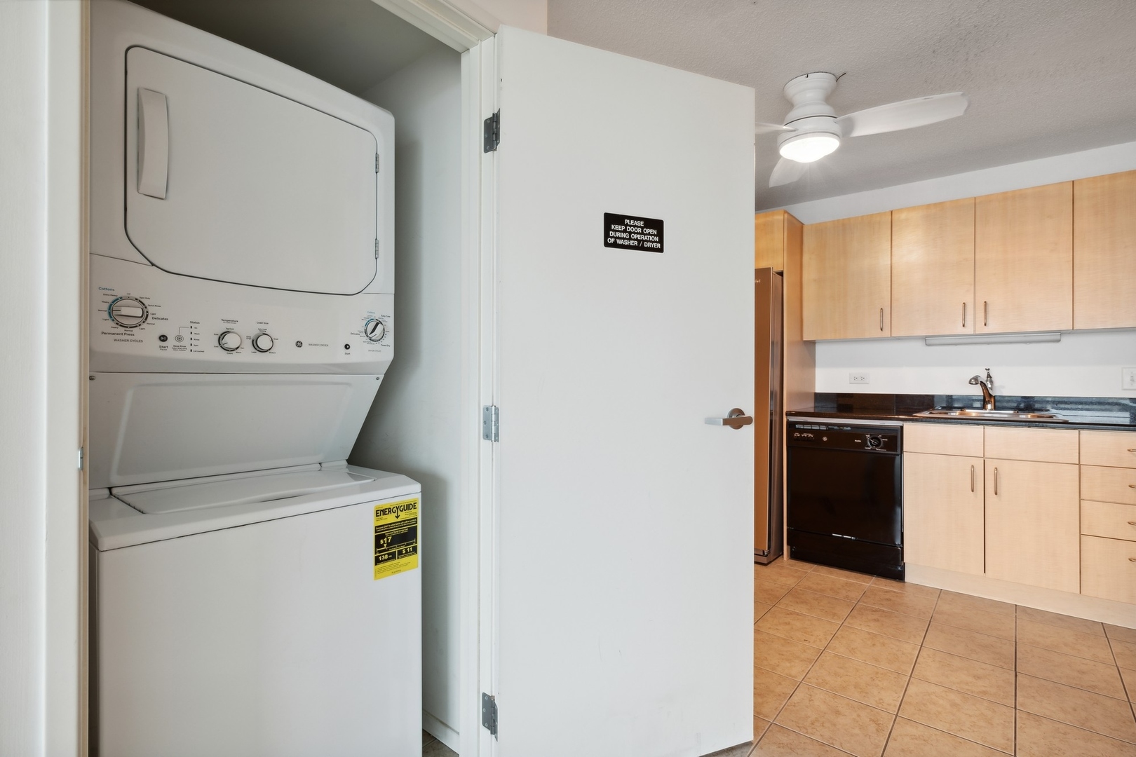 800 Elgin Road, Unit 1109 Evanston, IL 60201 - Photo 12 of 17 a kitchen with a refrigerator and cabinets
