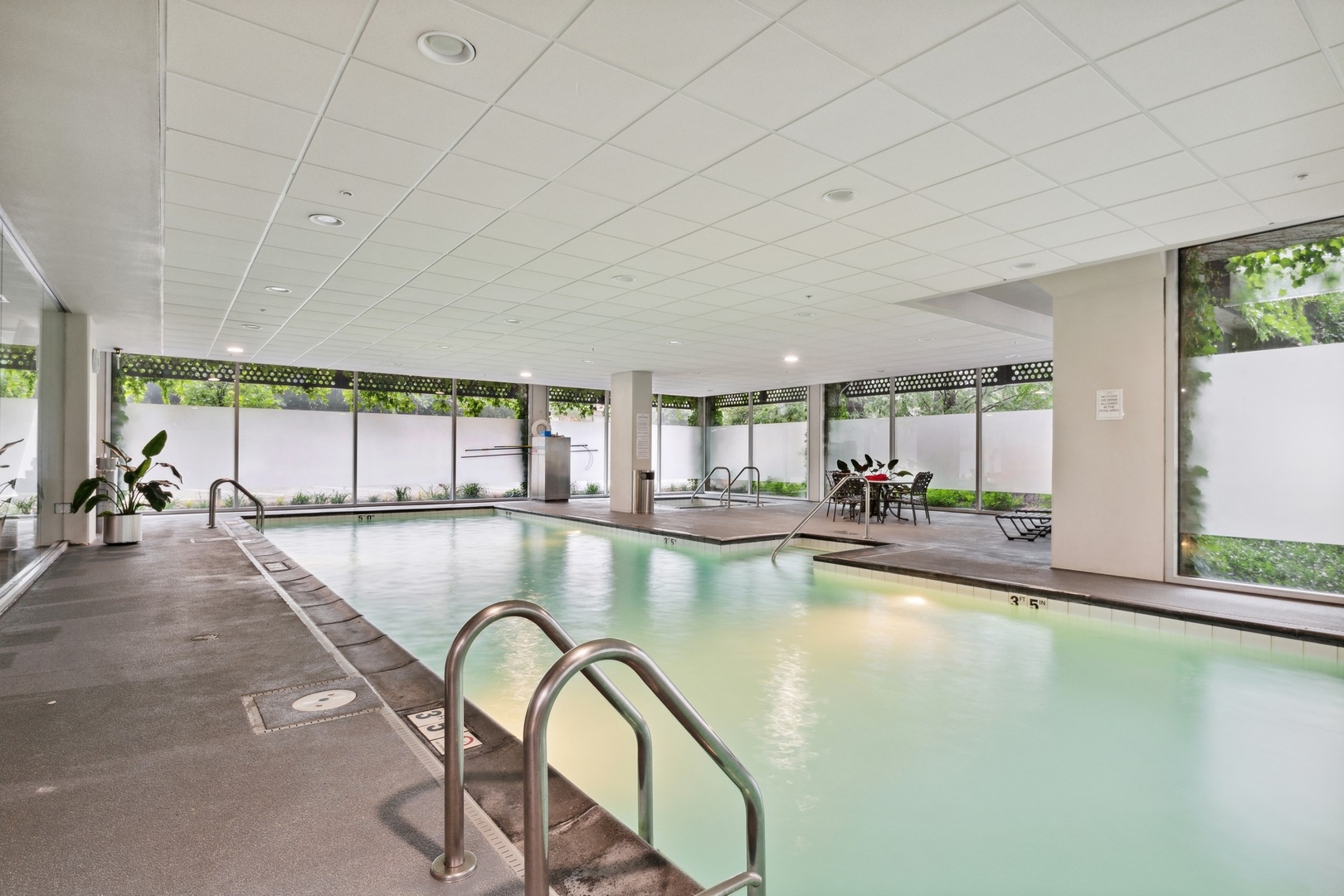 800 Elgin Road, Unit 1109 Evanston, IL 60201 - Photo 14 of 17 a swimming pool with outdoor seating and windows