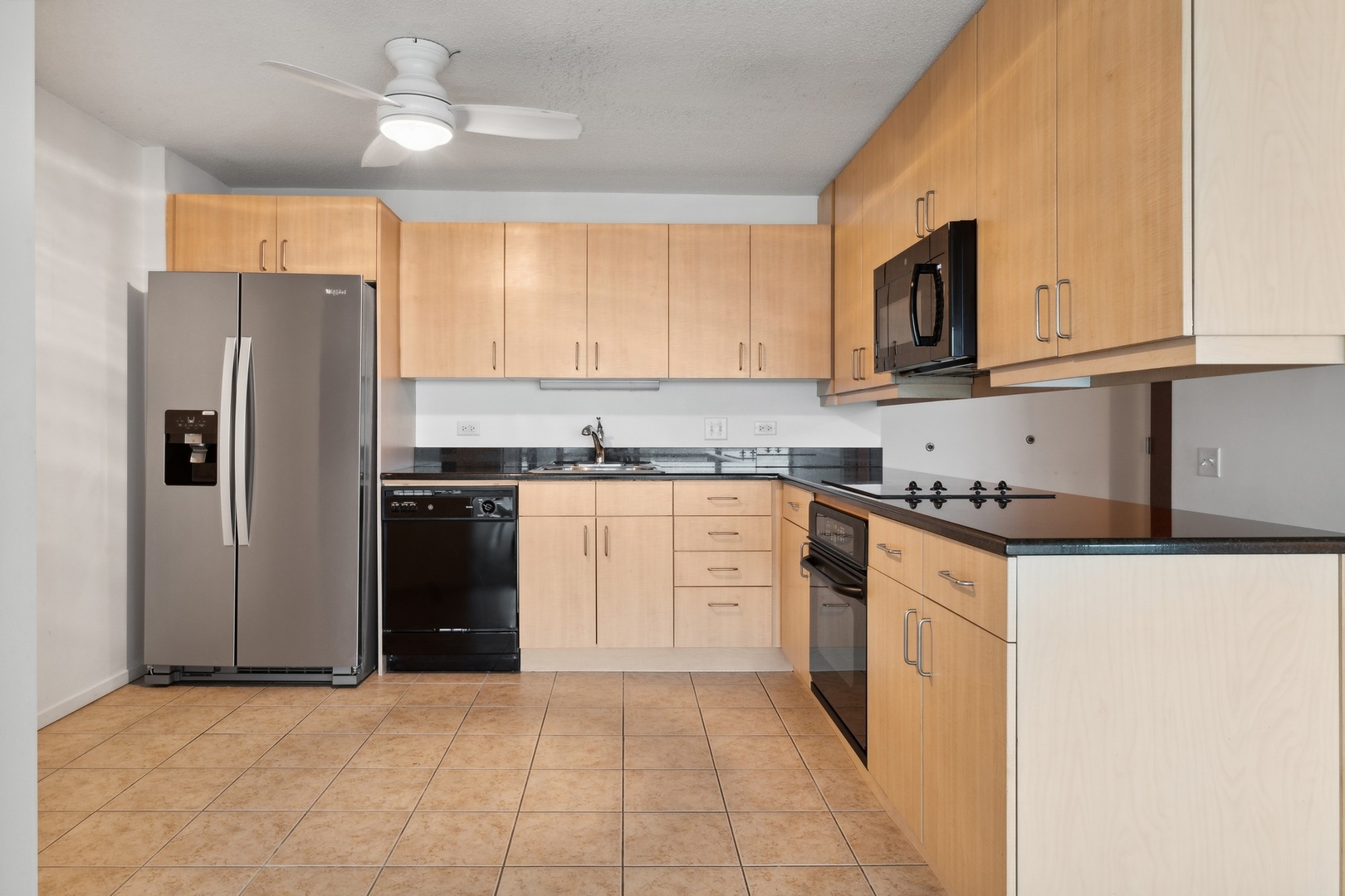 800 Elgin Road, Unit 1109 Evanston, IL 60201 - Photo 4 of 17 a kitchen with granite countertop a refrigerator stove top oven and sink