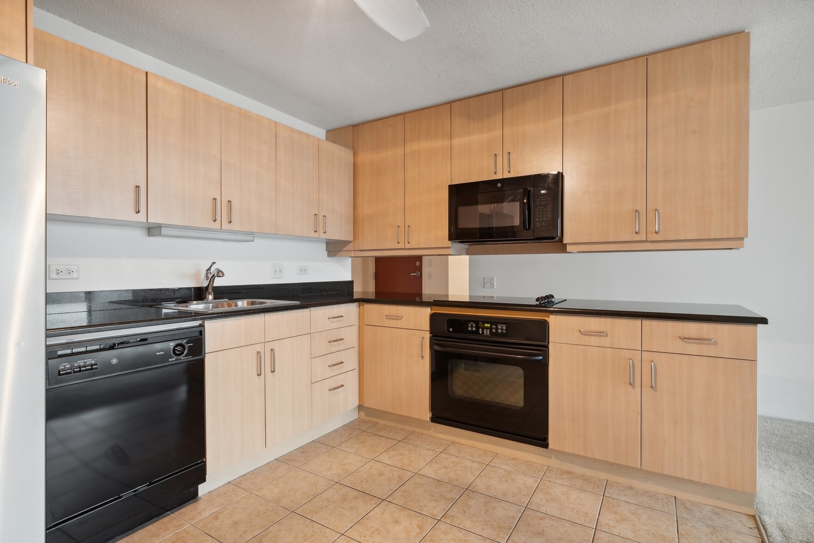 800 Elgin Road, Unit 1109 Evanston, IL 60201 - Photo 5 of 17 a kitchen with granite countertop white cabinets stainless steel appliances and a sink