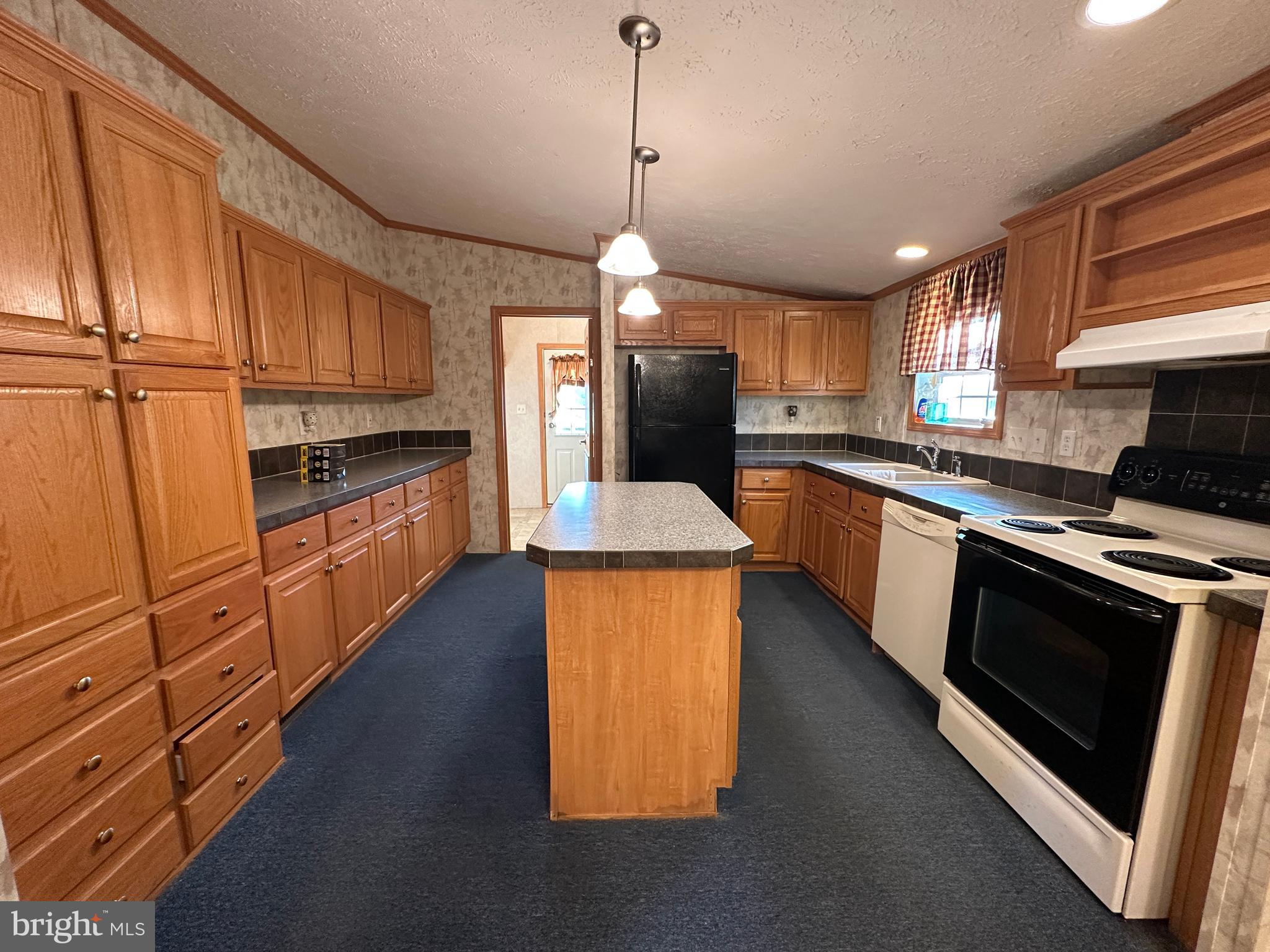 4391 Cito Road McConnellsburg, PA 17233 - Photo 35 of 67 a kitchen with stainless steel appliances granite countertop a stove a sink and a refrigerator