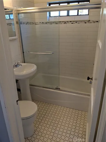 a kitchen with stainless steel appliances a refrigerator sink and window