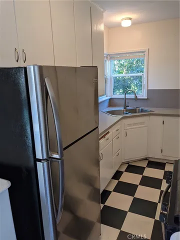 a kitchen with granite countertop a stove and a refrigerator