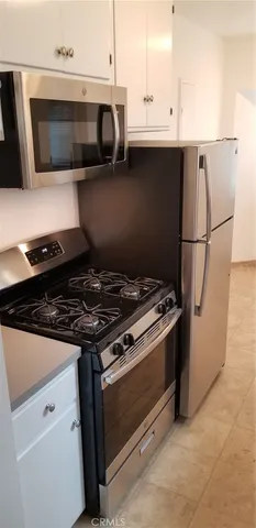 a kitchen with a refrigerator and a stove