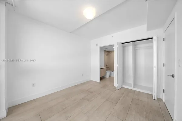 a bathroom with a bathtub shower sink vanity and toilet