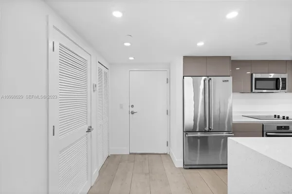 a kitchen with stainless steel appliances a refrigerator and a stove top oven