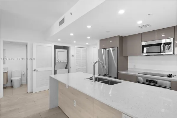 a kitchen with sink stove and cabinets