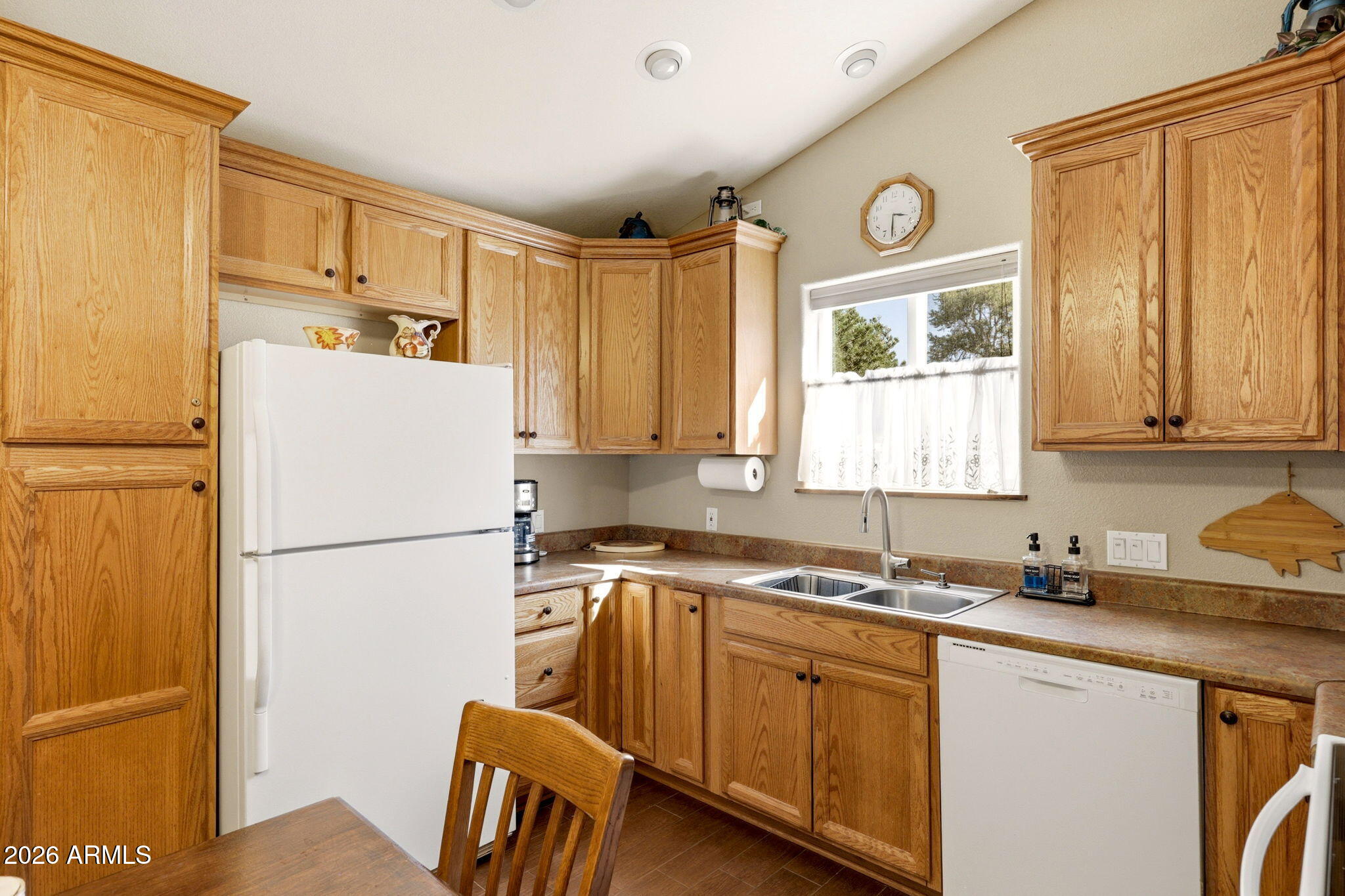 2112 Fishermans Road Overgaard, AZ 85933 - Photo 5 of 18 a kitchen with a refrigerator a sink and cabinets