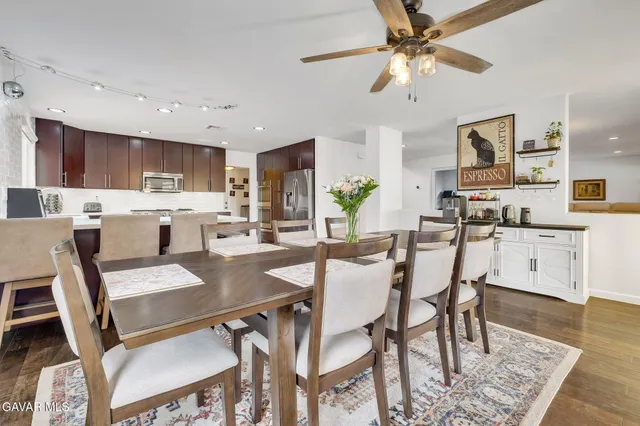 a view of kitchen with cabinets table and chairs