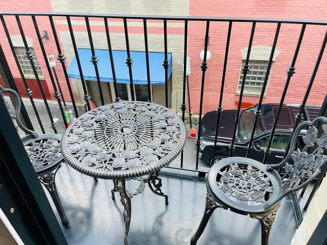 a view of a balcony with furniture