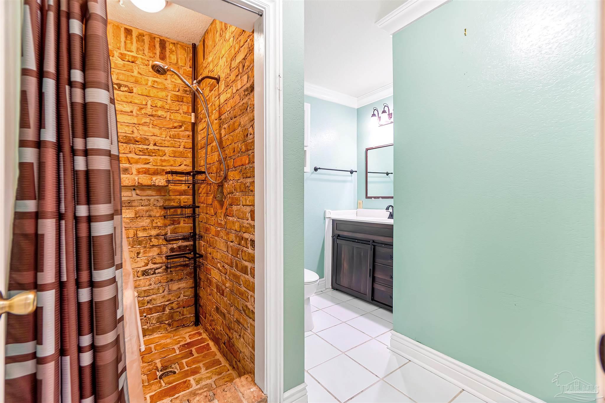 1961 Guseman Road Gulf Breeze, FL 32563 - Photo 13 of 37 a bathroom with a shower and a sink