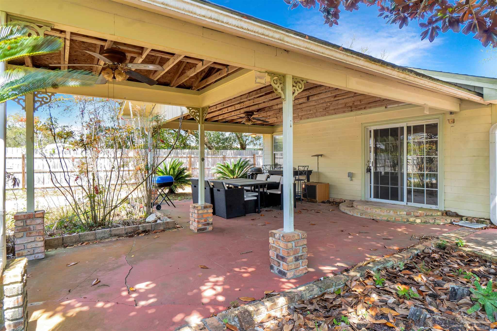 1961 Guseman Road Gulf Breeze, FL 32563 - Photo 17 of 37 a view of a chairs and table in the patio