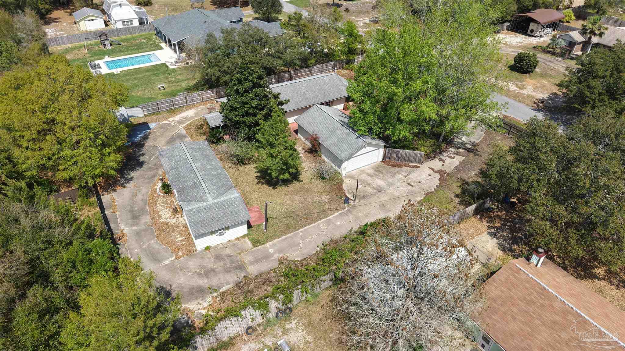 1961 Guseman Road Gulf Breeze, FL 32563 - Photo 34 of 37 an aerial view of a house with a yard and trees