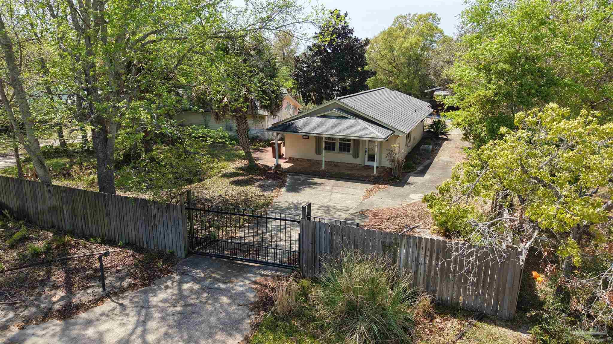 1961 Guseman Road Gulf Breeze, FL 32563 - Photo 36 of 37 a view of a wooden house with a small yard and wooden fence