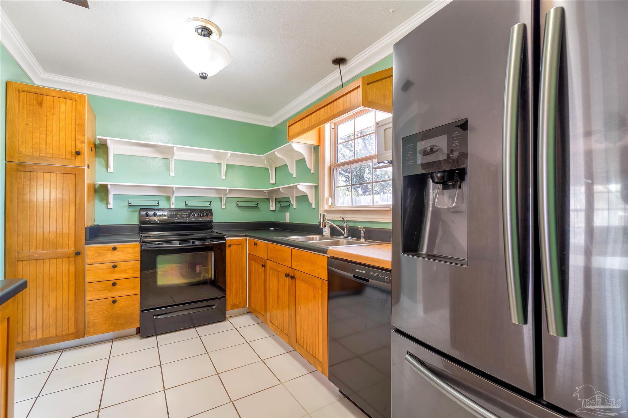 1961 Guseman Road Gulf Breeze, FL 32563 - Photo 7 of 37 a kitchen with stainless steel appliances granite countertop a refrigerator and a sink