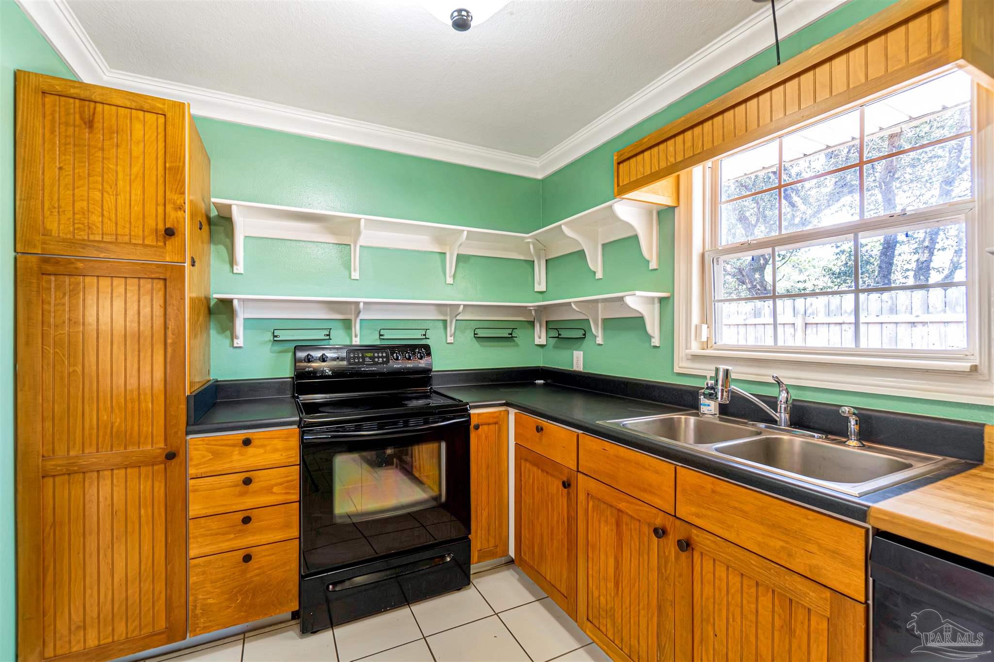 1961 Guseman Road Gulf Breeze, FL 32563 - Photo 8 of 37 a kitchen with stainless steel appliances granite countertop a sink and a stove