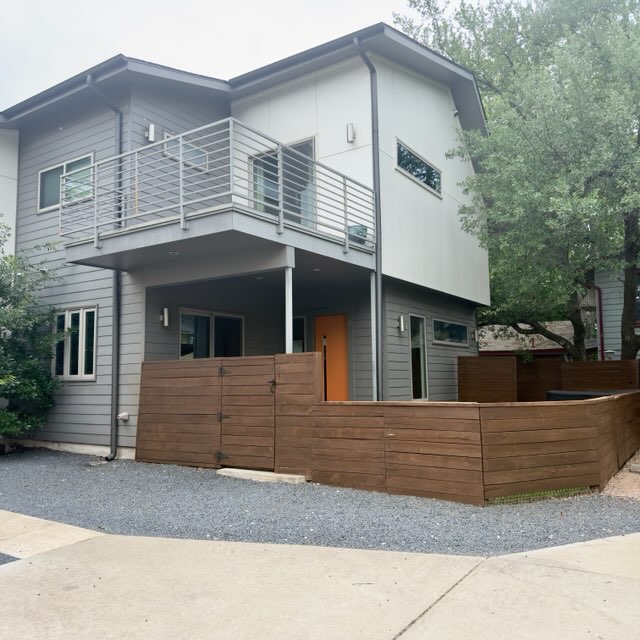 502 West 51st Street, Unit D Austin, TX 78751 - Photo 1 of 1 Modern architectural design featuring varied siding finishes and a prominent second-story balcony with metal railings
