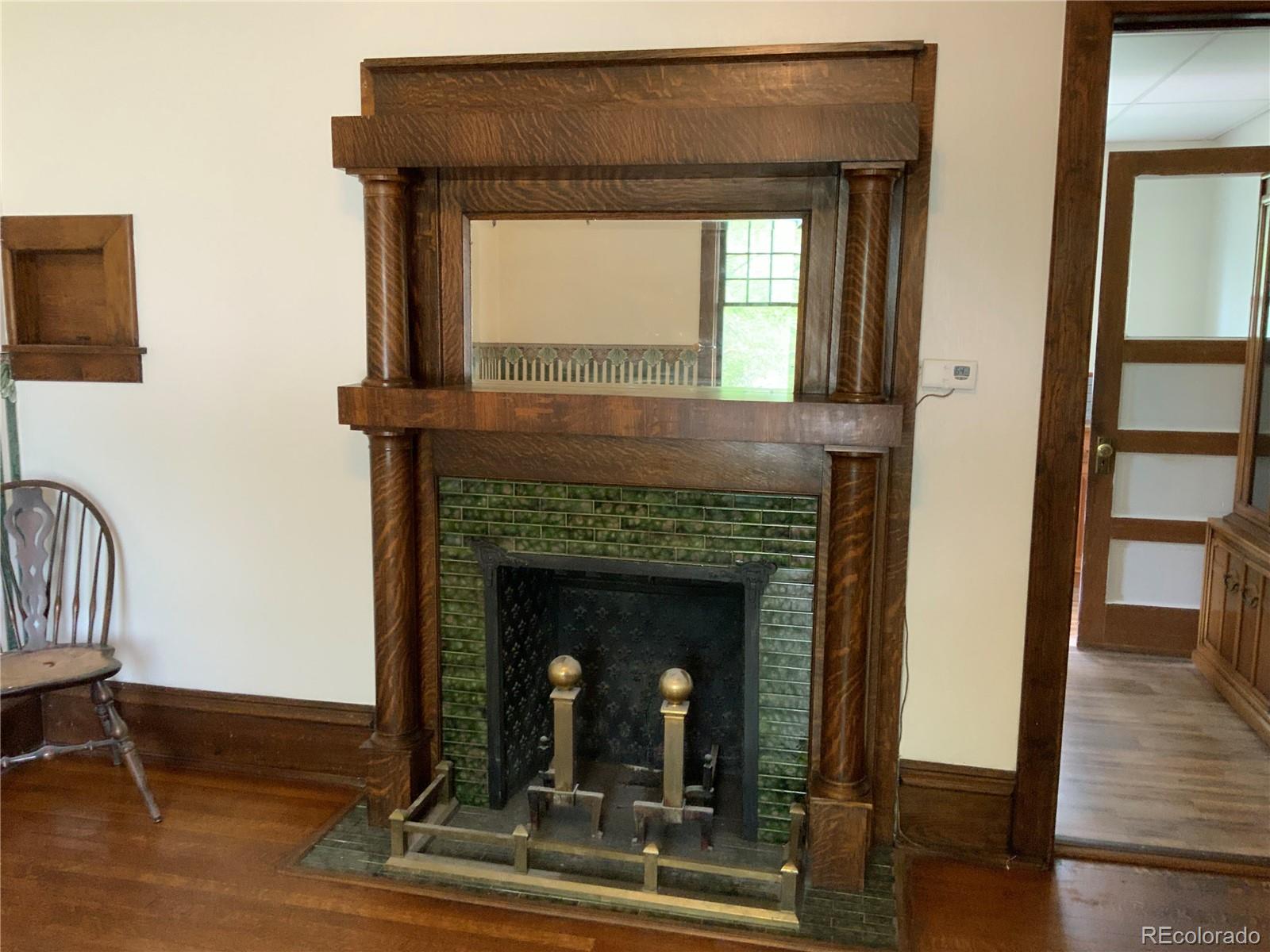 1011 Main Street Meeker, CO 81641 - Photo 17 of 28 a living room with a fireplace and a wooden floor