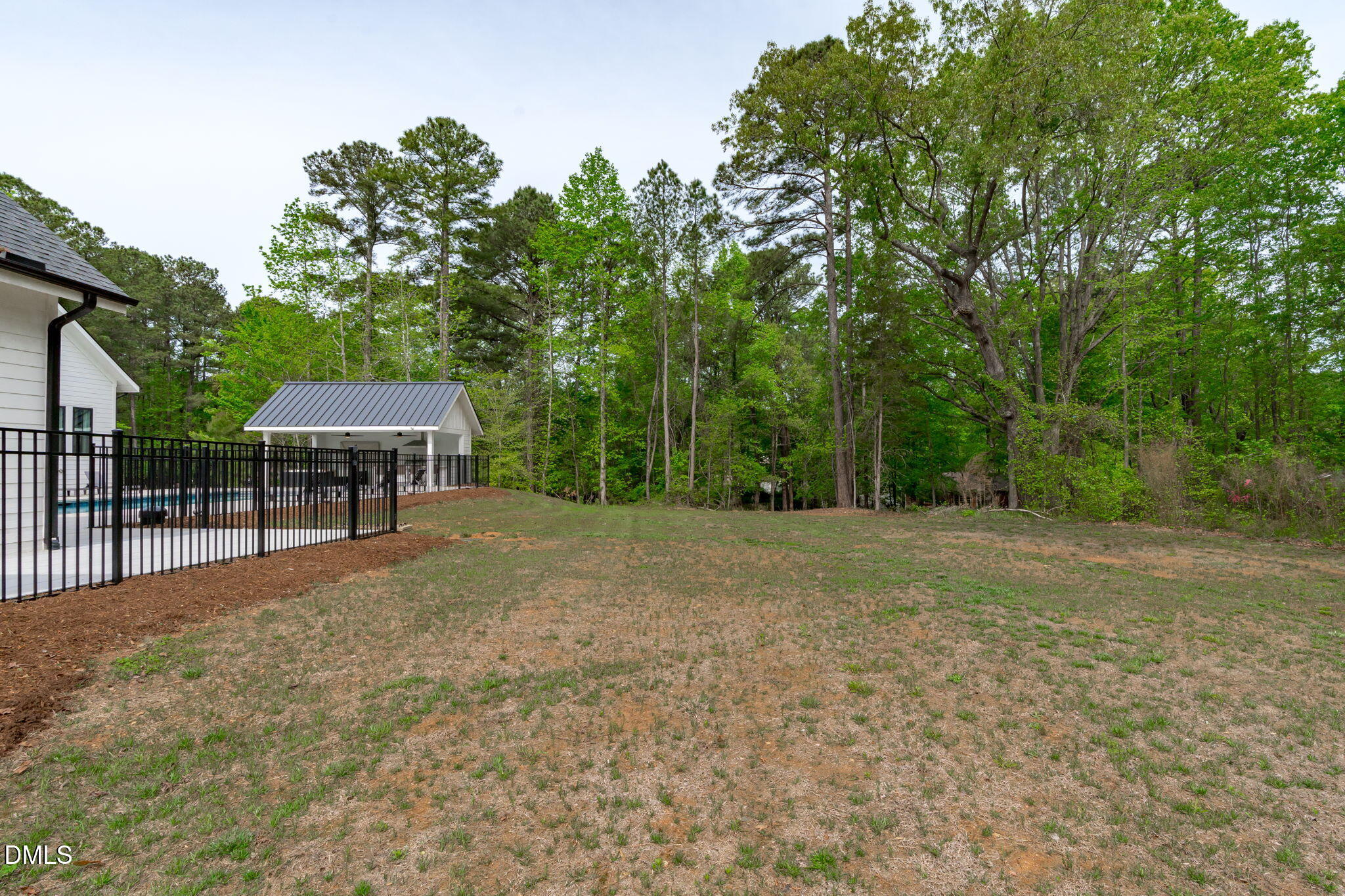 5005 Ten-Ten Road Apex, NC 27539 - Photo 47 of 60 Mulched beds around fenced area, hardwood and pine trees for visual appeal.