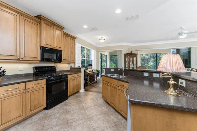 a living room with furniture kitchen view and a flat screen tv
