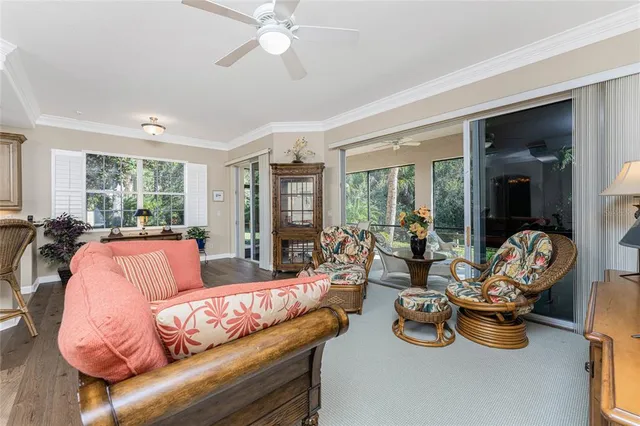 a bed sitting in a spacious bedroom next to a large window