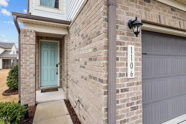 a view of a brick house with a large door