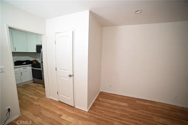 a view of a kitchen with wooden floor and a sink