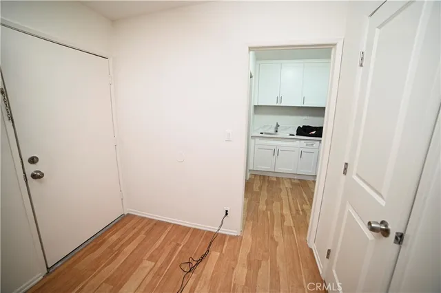 a view of a kitchen from a hallway