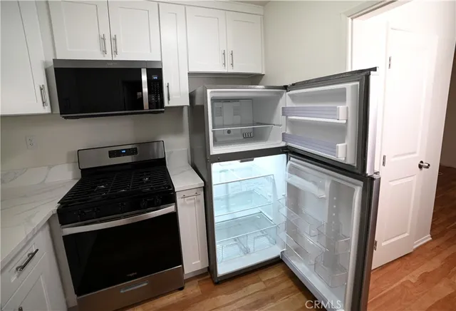 a kitchen with cabinets and steel stainless steel appliances