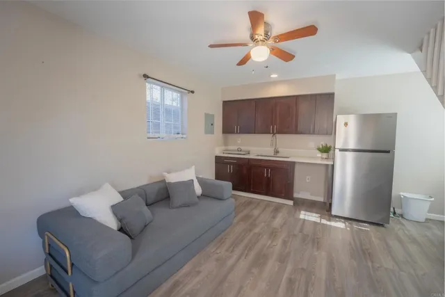 a living room with a couch and a ceiling fan