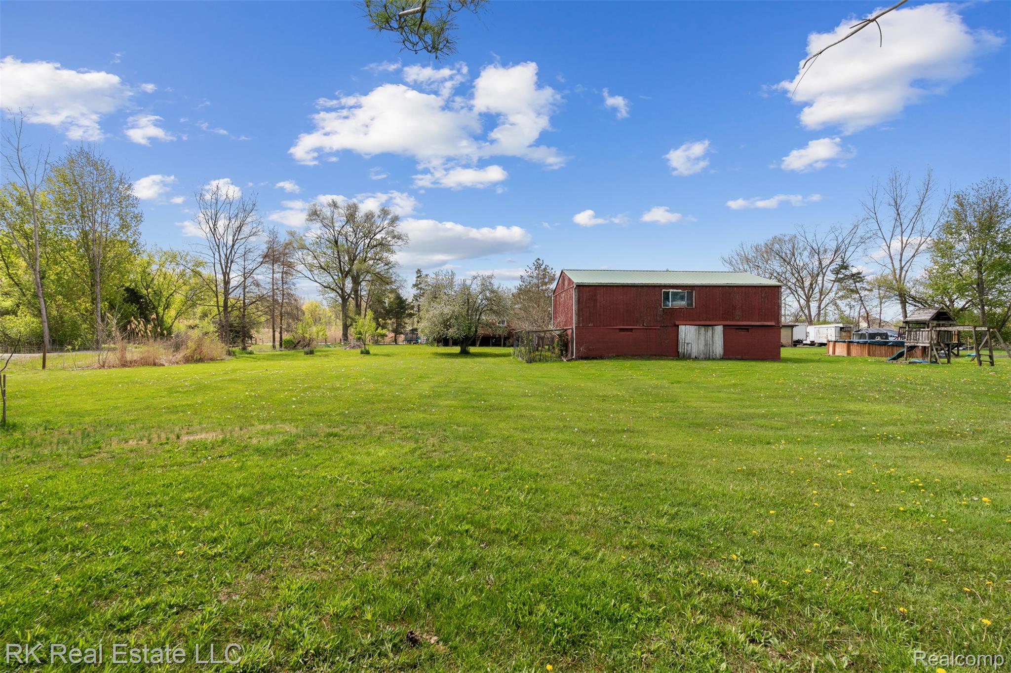 13799 31 Mile Road Washington, MI 48095 - Photo 39 of 40 View of green lawn featuring a barn and an outbuilding