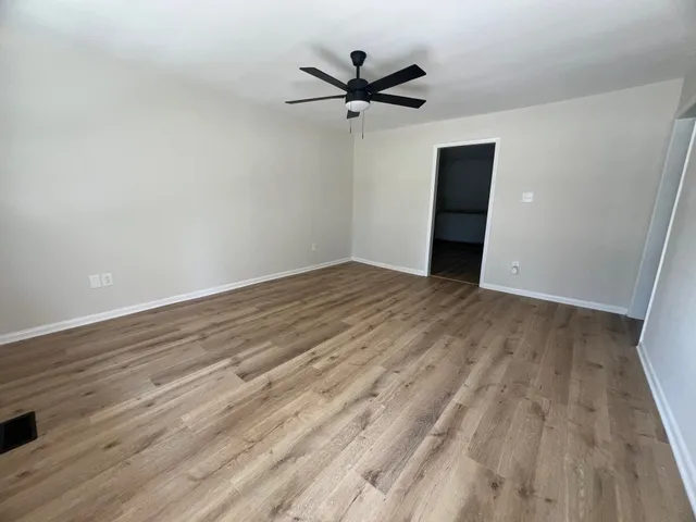wooden floor in an empty room with a window