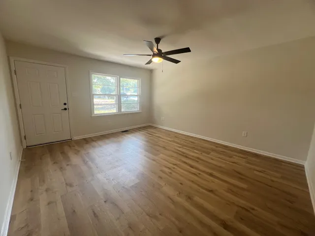 wooden floor in an empty room with a window
