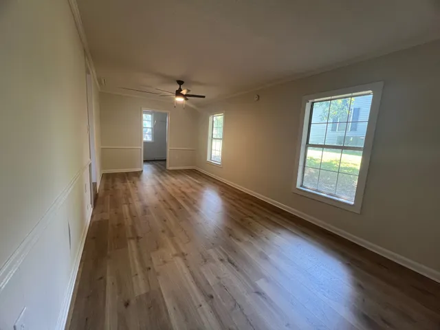 wooden floor in an empty room with a window