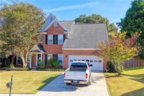 a front view of a house with a yard