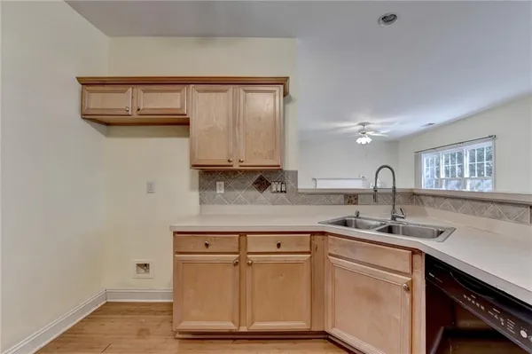 a kitchen with stainless steel appliances granite countertop a sink and cabinets