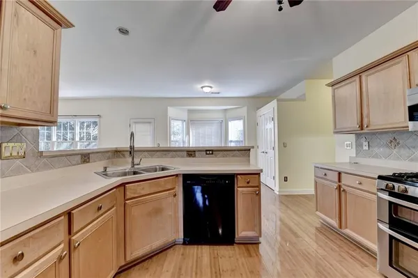 a kitchen with a sink cabinets and wooden floor